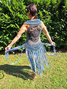 crocheted FESTIVAL VEST size XS-M Fantastic crochet vest with a floral pattern on the back and ties for lacing on the front - therefore adjustable and stretchable from XS-M (32-40), crocheted with love from soft cotton yarn.  Decorated with many long fringes made of different wool, effect yarns, fabrics and lace, which come into their own when walking, dancing and turning. The waistcoat can easily be machine washed at 30oC (possibly gather the fringes with a rubber band beforehand so that they d Blue Sleeveless Vest For Festival, Bohemian Fitted Sleeveless Vest, Fitted Bohemian Sleeveless Vest, Hippie Style Fitted Sleeveless Vest, Fitted Sleeveless Hippie Vest, Fitted Blue Vest For Festival, Bohemian Fitted Vest For Festival, Fitted Bohemian Vest For Festivals, Fitted Bohemian Blue Vest