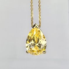 "This pendant is a pear shape yellow simulated diamond made with pure 14k yellow gold and 18\" yellow gold cable chain included item #5697 This pendant can be made with many different stone colors Message us for pricing on different color/type stones Approximate total carat weight:  2.00ctw diamond equivalent  -Center Stone Size:  10x7mm - approx 2.00ct diamond equivalent -Gem Type:  Simulated Diamond -Center Stone Shape:  Pear Shape -Center Stone Color:  Yellow -Center Stone Clarity:  VVS1 -Met Gold Solitaire Necklace With Brilliant Cut Teardrop Pendant, Gold Brilliant Cut Teardrop Pendant Necklace, Gold Teardrop Pendant Solitaire Necklace With Brilliant Cut, Yellow Gold Drop Necklace With Prong Setting, Classic Teardrop Solitaire Necklace In Yellow Gold, Classic Yellow Gold Teardrop Solitaire Necklace, Gold Teardrop Pendant Solitaire Necklace For Anniversary, Gold Solitaire Necklace With Brilliant Cut Pear-shaped, Yellow Gold Solitaire Necklace With Teardrop Diamond Pendant