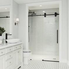 a white bathroom with two sinks and a large shower stall next to the bathtub