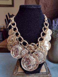 Stunning and large chunky statement jewelry necklace in gold tone accented with antique coins very heavy and jingly.  This one is a must have for eye catching and flattering jewelry.  In good vintage condition.  There is a tag with a symbol or 'N' attached but it is otherwise unsigned. Beautiful Etruscan revival style medallion coin layered necklace! Luxury Vintage Round Medallion Necklace, Vintage Gold Metal Coin Necklace, Gold-tone Metal Coin Necklace, Vintage Metal Coin Necklace, Art Curation, Etruscan Jewelry, Statement Jewelry Necklace, Ancient Roman Coins, Witch Earrings