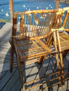 two wooden chairs sitting on top of a wooden deck