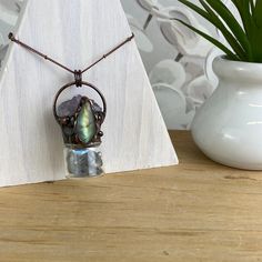 Fun and trendy Bohemian Style Gemstone Bottle Necklace with an accent stone is a unique and stylish piece of jewelry that combines the beauty of gemstones with a bohemian-inspired design. The necklace features a small bottle-shaped pendant, often made of glass, that is filled with natural gemstones of Amethyst, Labradorite, Jasper or Tiger's Eye. The accent stone is a larger and more striking stone that is set in a prominent position on the necklace, such as the top of the bottle pendant. Bohemi Unique Raw Stone Crystal Necklace For Jewelry Making, Labradorite Jewelry With Raw Stone As Gift, Unique Raw Stone Crystal Necklaces For Healing, Labradorite Crystal Necklaces With Natural Stones For Healing, Labradorite Crystal Necklace With Natural Stones For Healing, Healing Labradorite Crystal Necklace, Artisan Jewelry With Raw Stone For Healing, Artisan Raw Stone Jewelry For Healing, Adjustable Gemstone Jewelry