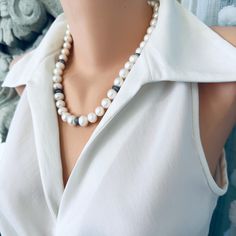 Add an elegant touch to any outfit with this Classic White Pearls Necklace. Crafted with exquisite attention to detail, this necklace features zircons pave rondelles for a stunning sparkle. The gunmetal plated and sterling silver materials lend a classy and timeless touch to this piece. Perfect as a Mother's Day gift or for a bride on her special day, this necklace is 20 inches in length and exudes sophistication and beauty. Complete your look with this exquisite piece of bridal jewelry and make Elegant White Jewelry With Stones, Elegant Single Strand Beaded Necklace For Jewelry Making, Classic Formal Necklaces With Stones, Elegant Pearl White Necklace With Polished Beads, Classic Formal Necklace With Stones, Elegant Bridal Necklace With Polished Beads, Elegant Necklaces With Round Natural Stone Beads, Elegant Necklace With Round Natural Stone Beads, Elegant Silver Pearl Necklace With Faceted Beads