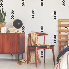 a bedroom with black and white arrows on the wall