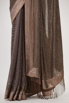 Charcoal wave patterned saree with sequin work and fringe pallu. Paired with embroidered sleeveless blouse.
Components: 2
Pattern: Embroidered
Type Of Work: Sequin
Neckline: Scoop
Sleeve Type: Sleeveless
Fabric: Chiffon
Color: Grey
Other Details: 
Sequin work
Embroidered blouse
Occasion: Sangeet,Reception - Aza Fashions Blouse For Women, Saree With Blouse, Blouse Online, Wave Pattern, Embroidered Blouse, Aza Fashion, Sleeveless Blouse, Sleeve Type, Types Of Sleeves