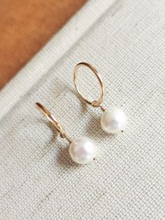 These dainty freshwater pearl hoops are the perfect accessory to complete that minimalist modern look! Great to give as a gift or to treat yourself! --------------------------- D E T A I L S * Earrings are made out of 14k gold-fill wire - Great for those sensitive to specific metals - Lightweight for easy wear * Hand-shaped rounded wire (14mm in diameter - 1.20mm thick) * Pearls measure 8mm * Ethical sourcing of all materials * Packaged neatly + securely in a reusable drawstring bag - ready to g Minimalist Round Pearl Earrings, Minimalist Pearl Earrings For Everyday, Minimalist Everyday Pearl Earrings, Minimalist Everyday Pearl Huggie Earrings, Minimalist Everyday Huggie Pearl Earrings, Minimalist 14k Gold-filled Hoop Earrings With Pearl Charm, Everyday Round Pearl Earrings With Ear Wire, Everyday Minimalist Huggie Pearl Earrings, Minimalist 14k Gold Filled Small Hoop Pearl Earrings