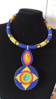 African Beaded Pendant Necklace,  Zulu Necklace, African Jewelry, Women Jewelry, Gift for her, Tribal necklace, Moms GiftThis pendant  necklace is superbly crafted.Main Color - Dark blue.Different colors can be available.Feel free to send me a convo or e-mail for any clarification or more information.Thank you for visiting and happy shopping! Traditional Blue Beaded Jewelry, Unique Blue Round Necklace, Traditional Blue Beaded Choker Necklace, Blue Beaded Round Pendant Jewelry, Unique Blue Beaded Necklaces, Unique Blue Beaded Chain Necklace, Traditional Blue Choker For Gift, Unique Blue Jewelry With Black Beads, Unique Blue Beaded Necklace