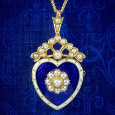 A beautiful antique Edwardian pendant from the turn of the 20th Century depicting a heart, with a pearl flower in the centre and a pearl bow on top. It's fashioned in 18ct gold and layered in a royal blue, guilloche enamel with a white border. It's very pretty and has remained in pristine condition. It's accompanied by a new 18ct wheat chain to display it on and is fitted with a pin at the back so it can also be worn as a brooch if preferred. We recommend you insure for £2,300. We can provide a Victorian Medallion Jewelry For Valentine's Day, Victorian Heart Pendant Jewelry For Formal Occasions, Victorian Heart Pendant Necklace For Wedding, Victorian Jewelry For Valentine's Day Memorial, Victorian Necklace For Formal Valentine's Events, Vintage Heart Pendant Jewelry With Pearl, Victorian Medallion Necklace For Valentine's Day, Blue Medallion Necklaces For Wedding, Blue Medallion Necklace For Wedding