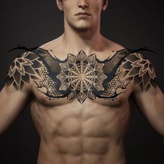 a man with tattoos on his chest and shoulder is looking at the camera while standing in front of a black background