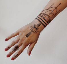 a woman's hand with tattoos on it and two lines in the middle of her arm