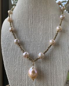 Large, baroque, blush hued pearls with pyrite accents. A beautiful statement piece for any occassion! Elegant High Luster Baroque Pearl Necklace, Elegant Teardrop Pearl Beaded Necklace, Elegant Baroque Pearl Necklace With High Luster, Unique Pearl Necklace With Round Beads, Elegant Beaded Baroque Pearl Necklace, Baroque Pearl Jewelry With High Luster, High Luster Baroque Pearl Jewelry, Elegant Baroque Beaded Jewelry, Elegant Beaded Bronze Jewelry