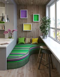 a room with a couch, table and some plants in the window sill next to it