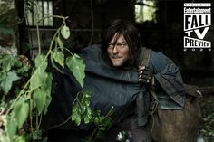 the walking dead season 3 character is hiding in the woods with his cape draped over his shoulders