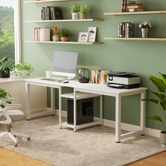 a home office with green walls and white furniture