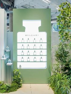 an advertisement for bvlgari is displayed in front of some plants and trees