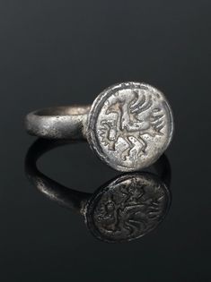 Warrior Bird. Bird with Raised Wings. Original Antique Ring by AntiqueJewls. Antique Signet Ring. Medieval Engraved Ring. Antique Ring. Ancient Artifact. Unique Ancient Jewelry. 1400-1600s Bronze, patina. Medieval ring with a large bird with raised wings. A bird with a thick neck and a powerful beak. Ring with a round shank and a circular bezel with a furrow along the border. Round in section. Ancient Rings, Medieval Ring, Thick Neck, Bird Ring, Medieval Rings, Bird Rings, Ring Man, Men Rings, Iron Ring