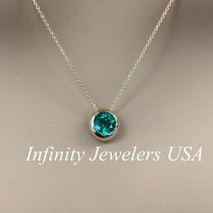 "The pendant pictured is a lab created emerald #6750 Video shows 14k White Gold -Approximate total carat weight: approx. 1.00ctw diamond equivalent -Center Stone Size: 6.5mm - approx. 1.00ct diamond equivalent -Center Stone Shape: round -Gem Type: lab created emerald -Stone Clarity: VS2 -Stone Color: lively rich green -Moh's Scale: 8.5 hardness -Metal Type and Purity: 14k yellow gold -Setting: bezel set floating necklace -Chain: delicate 14k gold chain / heavier option with lobster claw availabl Round Emerald Necklace As Gift, Formal Emerald Necklace With Round Pendant, Round Emerald Necklace For Anniversary, Anniversary Birthstone Necklace With Prong Setting, Emerald Round Pendant Necklace, Elegant May Birthstone Jewelry With Tension Setting, Formal Jewelry With Tension Setting In Round Pendant, Formal Round Pendant Jewelry With Tension Setting, Elegant Green Round Birthstone Necklace