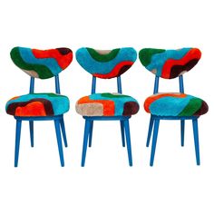 three chairs with different colors and designs on them