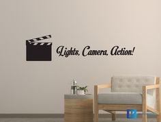 a chair sitting in front of a wall with the words lights, camera action on it