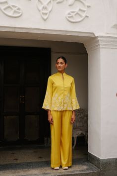 PRODUCT DETAIL: Discover a truly unique blend of structured elegance and fashionable comfort with our Yellow Embroidered Coat with Wide Pants. This ensemble redefines traditional and modern fashion, making it the perfect choice for upcoming festivities and formal occasions. The top, adorned with intricate embroidery, a Wedding Palazzo Set With Embroidered Sleeves For Eid, Festive Fitted Palazzo Set With Embroidered Sleeves, Festive Embroidered Straight Pant Set, Embroidered Straight Palazzo Set For Festive Occasions, Festive Embroidered Straight Palazzo Set, Embroidered Festive Straight Palazzo Set, Fitted Palazzo Set With Embroidered Sleeves, Elegant Floral Embroidered Pant Set For Diwali, Fitted Sets With Straight Pants For Diwali