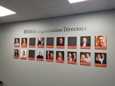 a group of people are hanging on the wall in front of an organization director's office