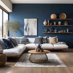 a living room with blue walls and white furniture in the corner, including a large sectional couch