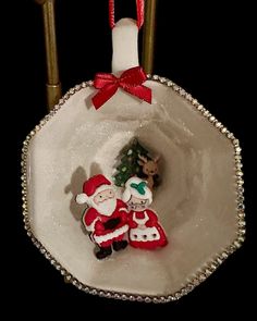 an ornament hanging from a christmas tree in a bowl