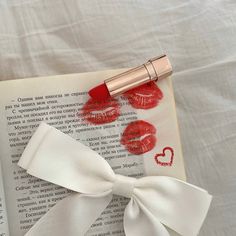 a book with lipstick and a bow on it