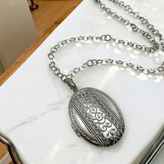 Hello and welcome, Gorgeous in perfect condition piece here. Solid sterling silver, this thick pendant opens up to hold and treasure 42 photos. Will make an amazing gift for any lady. Cleaned and polished inside and out. Marked 925 and features Silpada charm logo. Comes with an 30" large circle chain, also stamped 925. Locket is approximately 2" long, about 1-11/16" wide. Silver Heirloom Oval Necklace, Classic Pendant Locket Necklace With Intricate Design, Silver Oval Link Necklaces For Weddings, Silver Oval Link Necklace For Wedding, Antique Silver Necklace With Polished Finish, Heirloom Locket Pendant Necklace With Intricate Design, Heirloom Pendant Locket Necklace With Intricate Design, Heirloom Silver Medallion Jewelry, Heirloom Locket Necklace With Intricate Design