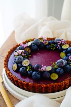 a blueberry cheesecake with fresh berries on top