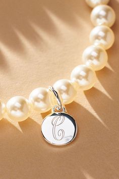 Elevate your special day with the exquisite Pearl Monogram Bracelet, a touch of personalization. Whether you opt for the initial of your cherished partner or choose to commemorate a beloved one, let this bracelet be a timeless symbol of connection and closeness. | Pearl Monogram Pearl Bracelet by Anthropologie in Alphabet, Women's, Gold/Plated Brass/Glass Classic Personalized Initials Bracelet, Classic Initials Bracelet, Perfect As Gift, White Gold Initials Bracelet For Anniversary, Classic Bracelets With Initials, Customizable Elegant Name Bracelet, Elegant Adjustable Initials Charm Bracelet, Elegant Silver Bracelets With Initials, Elegant Sterling Silver Initials Name Bracelet, Elegant Sterling Silver Name Bracelet With Initials