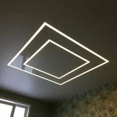 a room with a window and some lights on the ceiling