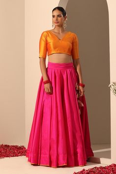 Hot pink solid lehenga crafted in tafetta silk with statement tassels. Paired with a blouse and gota lace bordered dupatta.
Components: 3
Pattern: Embroidered
Type Of Work: Gota lace
Neckline: V Neck
Sleeve Type: Elbow
Fabric: Lehenga and Blouse: Tafetta Silk, Dupatta: Soft Net
Color: Pink
Other Details: 
Length:
Lehenga: 40 inches
Dupatta: 2.5 mtrs
Dupatta width: 44 inches
Occasion: Mehendi and Haldi - Aza Fashions Diwali Party Sets With Latkans, Party Sets With Latkans For Diwali, Festive Pink Sharara With Tassels, Festive Pink Tassel Sharara, Navratri Party Sets With Latkans, Party Sets With Latkans For Navratri, Traditional Pink Sets With Tassels, Diwali Saree Set With Tassels, Diwali Sets With Tassels