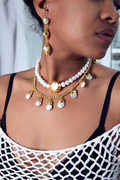 Elevate your style with our Teardrop Pearl Necklace. This elegant piece features lustrous freshwater pearls and a versatile Cuban link chain. The multi-charm design adds a touch of extravagance, making it a must-have accessory for any occasion. Upgrade your look with this sophisticated style. 18k gold-plated, freshwater pearl 14" necklace | 2" extension chain | 20 mm pearl pendants Multiple sizes are available Handmade in Los Angeles with imported materials Follow these tips to keep your jewelry Pearl Dangle Chain Necklace, Elegant Metal Chain Necklace With Pearl Drop, Baroque Pearl Drop Necklace With Pearl Chain, Dangle Pearl Drop Necklace For Party, Pearl Pendant Necklace With Pearl Drop, Pearl Drop Dangle Necklace For Party, Elegant Dangle Pearl Necklace With Beaded Chain, Elegant Pearl Necklace With Beaded Dangle Chain, Pearl Dangle Necklace With Charm For Party