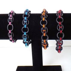 "Rubber stretchy chainmaille bracelets in an original unique pattern I named dragon eyes. Made with black EPDM rubber rings and colored anodized aluminum rings. Slip on style stretches over the hand, no clasp, due to the stretchy nature the sizing is approximate. Nickel free jewelry Small fits wrist up to 6.5\" inches Medium fits wrists up to 7.5\" inches Large fits wrists up to 8.5\" inches **more colors available by custom order, other sizes available up on request | Rubber Chainmaille Stretch Chainmaille Jewelry Patterns, Chainmail Patterns, Eyes Pattern, Dragon Eyes, Chainmaille Jewelry, Chainmail Jewelry, Chainmaille Bracelet, Handmade Chain, Nickel Free Jewelry