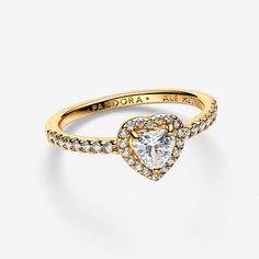 Tell the world you believe in love with our Elevated Heart Ring. A heart-shaped clear cubic zirconia sits at the centre of the ring accented by sparkling pavé in the frame of the setting and along the front of the band. - Pandora Elevated Heart Ring - 14k Gold-plated unique metal blend / Cubic Zirconia / Clear - Sz. 6 Gold Ring Pandora, Gold Rings Pandora, Quinceañera Rings, Pandora Elevated Heart Ring, Pandora Promise Rings, Pandora Heart Ring, Elevated Heart Ring, Promise Rings Pandora, Pandora Rings Heart