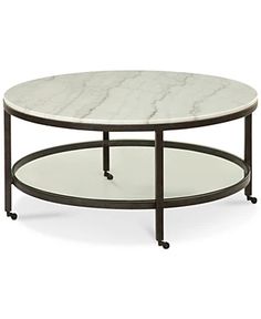 a white marble top coffee table with black metal frame and casteors on the legs