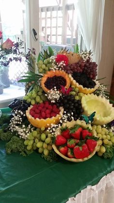 a table topped with lots of different types of fruits and veggies on top of it