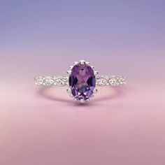 Introducing the exquisite "Juliet" Amethyst and White Topaz Ring – a timeless symbol of love and elegance. Crafted with passion and precision, this enchanting piece will captivate hearts and turn heads wherever it graces your hand. At the center of this ring lies a resplendent amethyst gemstone, deeply alluring with its regal purple hue. The amethyst, known for its association with tranquility and balance, embodies the spirit of royalty, making you feel like a true queen. Its mesmerizing violet Timeless Symbol, Symbol Of Love, Purple Hues, Moon Child, Topaz Gemstone, Topaz Ring, Love Symbols, Amethyst Gemstone, White Topaz