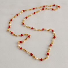 Embrace the allure of tradition with our Coral Pearl Necklace--a fusion of antique charm and Jaipuri elegance. This Mala set, a blend of traditional and fancy elements, features vibrant coral color beads and lustrous pearls. The necklace exudes sophistication, complementing any outfit effortlessly.  This personalized jewelry piece is my own design, and I welcome any customization requests. Elevate your style with this exquisite Indian jewelry. Length - 30 inch Indian Coral Jewellery Gold, Coral And Pearl Jewellery, Pearl And Coral Gold Chain, Elegant Kundan Necklace For Puja, Elegant Kundan Necklace With Pearl Chain For Puja, Bollywood Style Long Necklace For Gifts, Elegant Beaded Necklaces For Diwali Celebration, Elegant Beaded Necklaces For Diwali, Pearl Chain Necklace For Diwali Gift