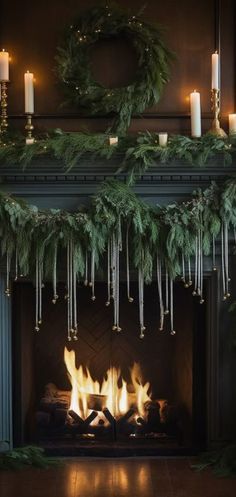 a fireplace with candles and garland on it