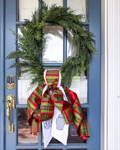 a christmas wreath is hanging on the front door