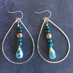 Please note all stones are unique. This is a photo of the first pair made. Arizona oyster lapis turquoise look like delightful landscapes. I have combined these unique teardrops with peacock and multicolored freshwater pearls on sterling silver. I have used my KRISTIANA hammered hoops in the medium size in sterling silver to create these hoops. The approximate length is 2.5". Please choose your earwire preference. Unique Handmade Turquoise Beaded Earrings, Green Teardrop Jewelry With Pearl Drop, Bohemian Sterling Silver Jewelry With Pearl Drop, Green Teardrop Pearl Drop Jewelry, Silver Teardrop Earrings With Natural Stones, Teardrop Czech Glass Wire Wrapped Jewelry, Bohemian Sterling Silver Pearl Drop Jewelry, Blue Teardrop Pearl Drop Jewelry, Turquoise Teardrop Jewelry With Polished Beads