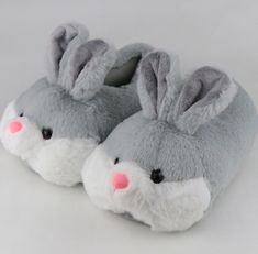 a pair of gray and white slippers with bunny ears