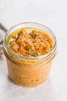 a jar filled with food sitting on top of a table