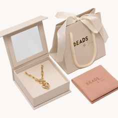 an open box with a necklace and key inside