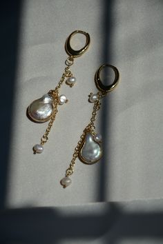 Item Overview ‧͙･༓☾ * Handmade item * Ships worldwide from Alexandria, Virginia Item Details ‧͙･༓☾ Ethereal oval hoop Pearl drop earrings. Beautiful combination of baroque pearls and freshwater pearls to create this gorgeous drop earring. Very trendy and unique and is a great staple to have in your collection. Lightweight design suited for everyday. * Brass, 14k Gold Plated, Baroque Pearl, Freshwater Pearl * 8.25 cm * Moon Made ⟡ Thank you very much for stopping by. Come back soon! ͙･༓☾ mackpear Pearl Teardrop Chandelier Earrings For Pierced Ears, Gold-plated Teardrop Pearl Earrings, Teardrop Baroque Pearl Chain Earrings, Yellow Gold Pearl Drop Dangle Chandelier Earrings, Gold Plated Teardrop Pearl Earrings, 14k Gold Filled Drop Pearl Earrings, Dangle Earrings With Baroque Pearl Chain, Pearl Drop Baroque Pearl Earrings For Anniversary, Teardrop Pearl Charm Earrings In 14k Gold