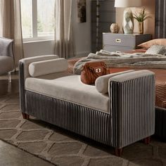 a bed room with a neatly made bed and two chairs