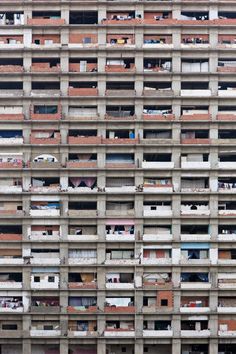 an apartment building with lots of windows and balconies