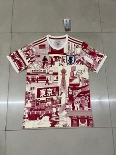 a red and white t - shirt on display in a store floor with chinese characters all over it